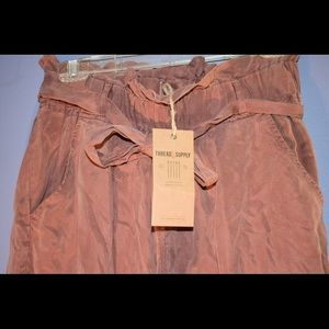 Long burnt orange paper bag pants